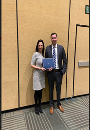 Dr. Evan Bander receives the James Rutka Pediatric Brain Tumor at the CNS 2022 from Dr. Jennifer Moliterno, AANS/CNS Section on Tumors Awards Chair.