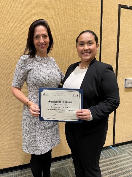 Dr. Danielle Miyagishima receives the Journal of Neuro-Oncology Award at the CNS 2022 from Dr. Jennifer Moliterno, AANS/CNS Section on Tumors Awards Chair.