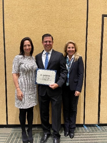 Dr. Michael Ivan receives the Journal of Neuro-Oncology Award at the CNS 2022 from Dr. Jennifer Moliterno, AANS/CNS Section on Tumors Awards Chair.