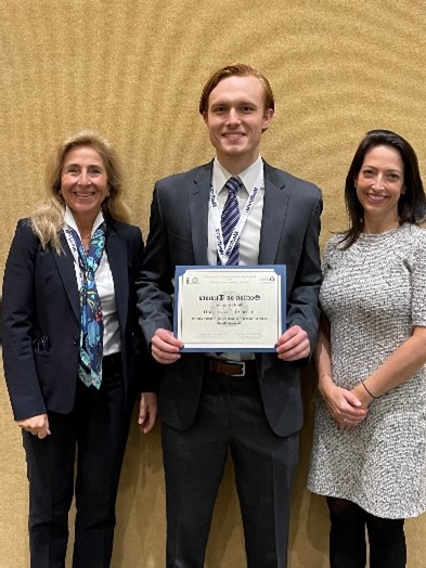 Dr. Jeffrey Traylor receives the Integra Award at the CNS 2022 from Dr. Jennifer Moliterno, AANS/CNS Section on Tumors Awards Chair.