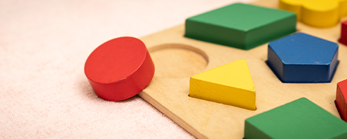 Banner closeup of colorful wooden Montessori sensorial material learning, Shape and color block. Kindergarten educational toys, Thinking process, Cognitive skills, Learn Through Play tools concept.